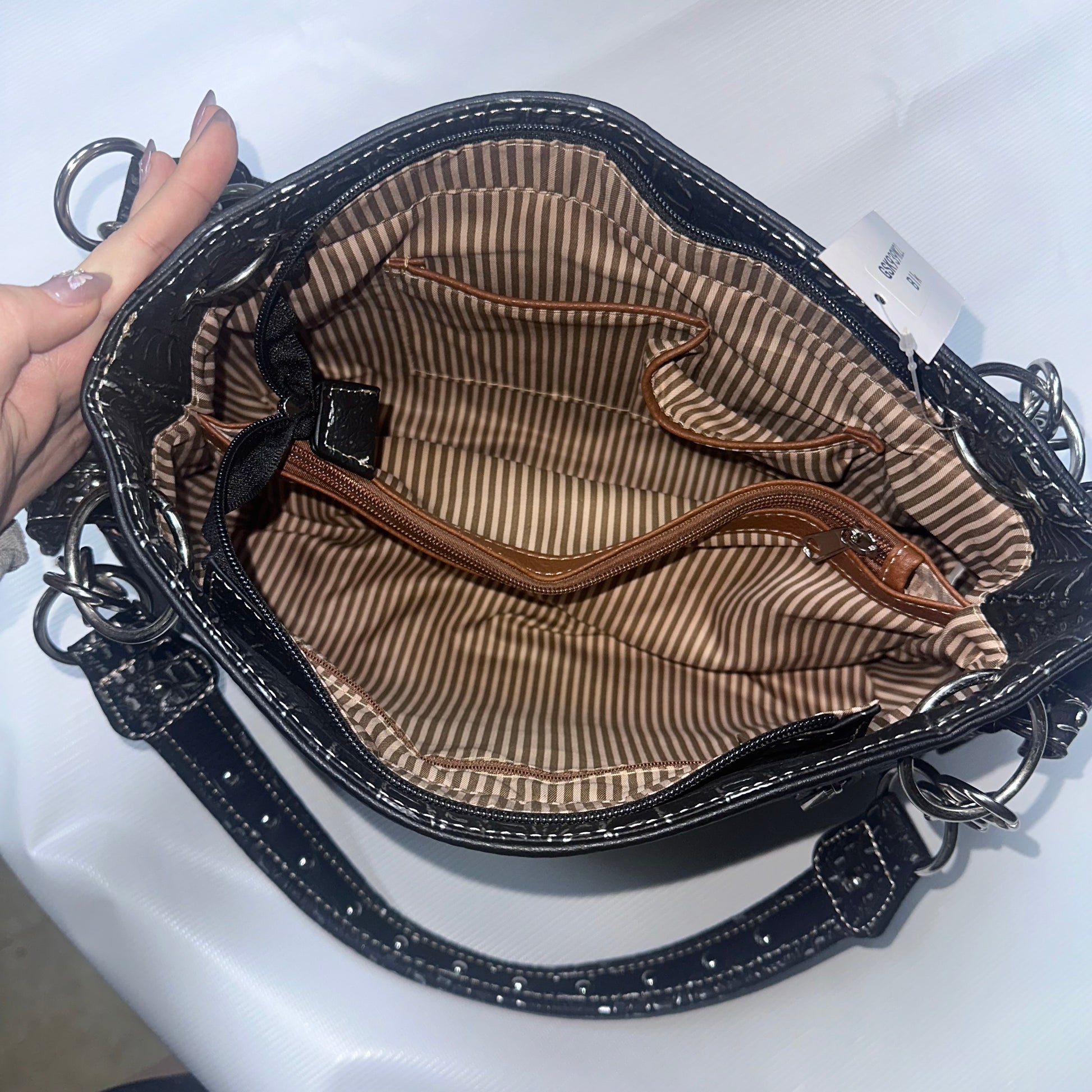 Black handbag with striped interior on a white background