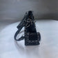 Black leather purse with chain on a white background
