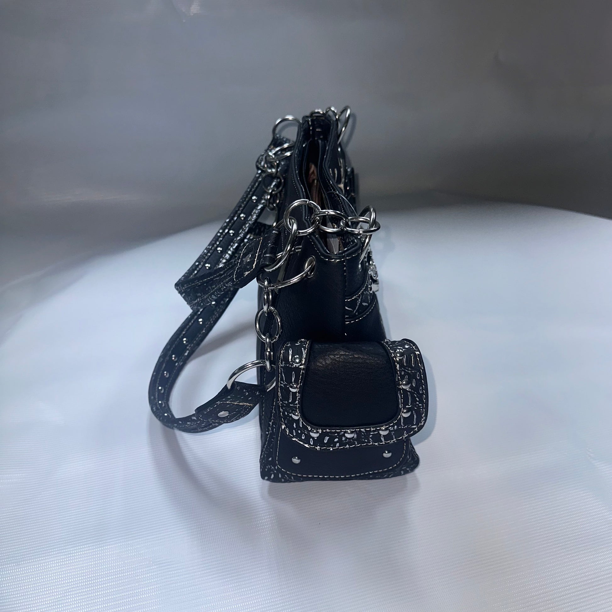 Black leather purse with chain on a white background