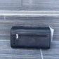 Black wallet with a tag on a textured surface
