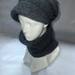 Mannequin head wearing a gray knit hat and scarf on a white background