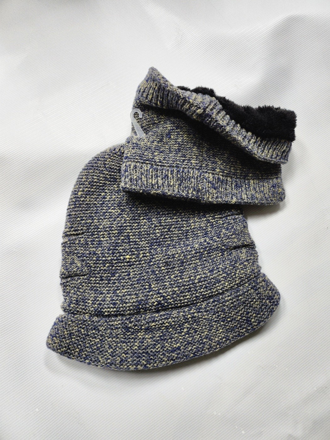 Gray knitted beanie hat and scarf set with a fur lined collar on a white background