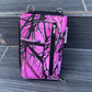 Pink and black camouflage phone case on a textured surface